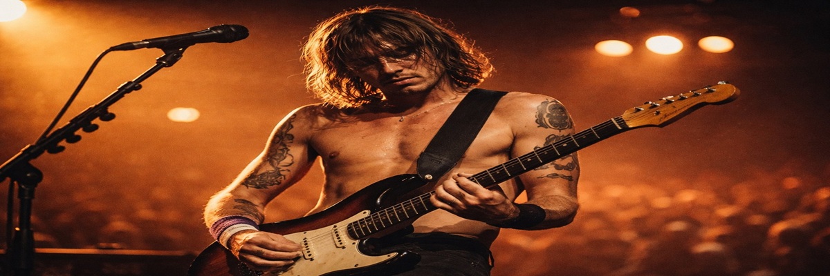 Guitarist performing on stage in a documentary-style concert scene